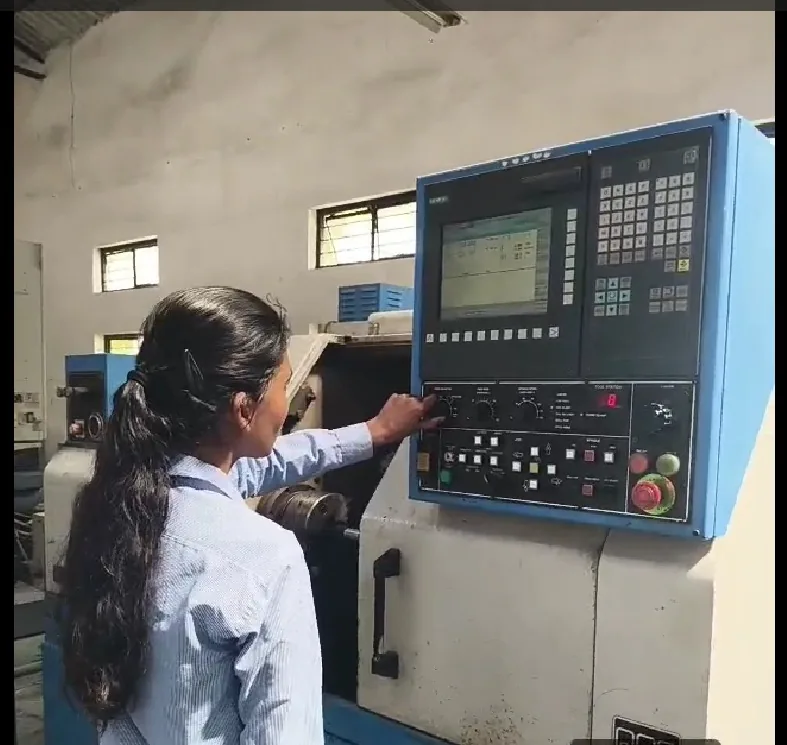 A candidate operating a CNC machine controller during a technology-enabled assessment