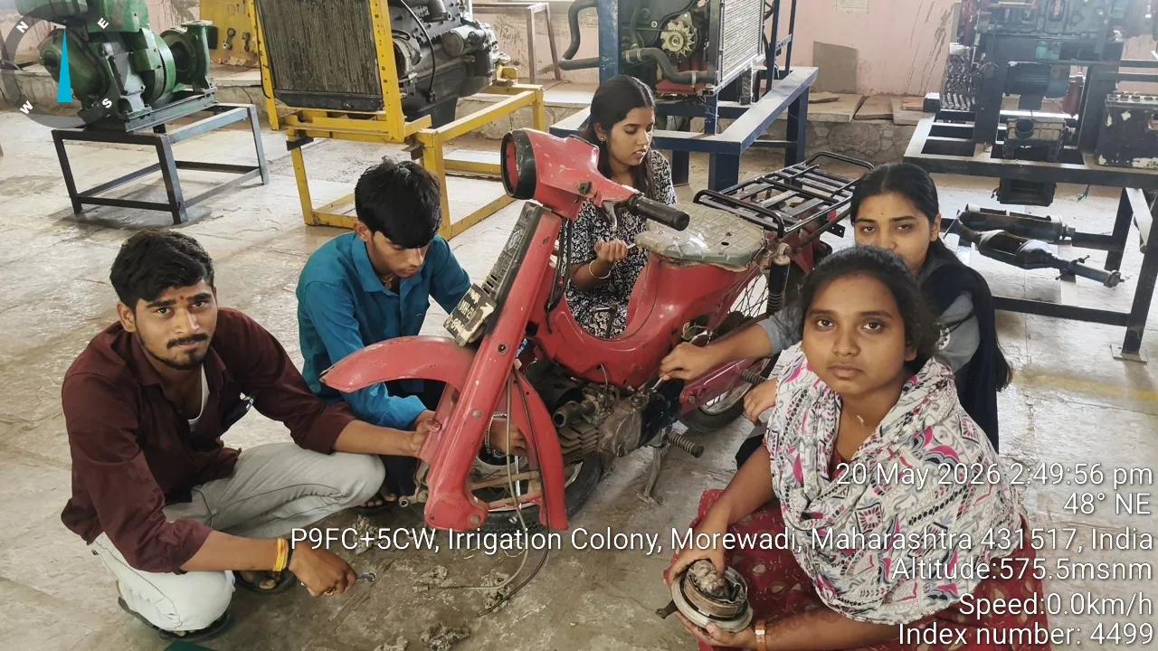 Trainees at a hands-on two-wheeler servicing assessment